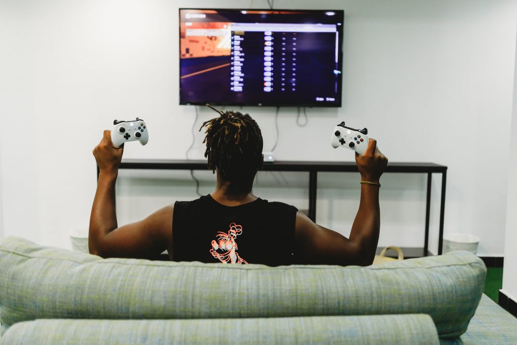 man sitting on couch ready to play fortnite