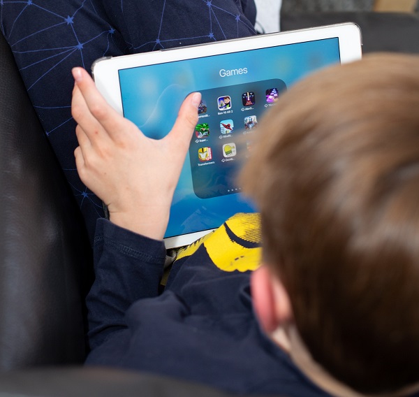 kid playing computer game on tablet